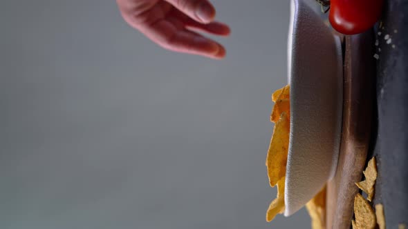 Hand of Man Taking Tortilla Chip From Bowl