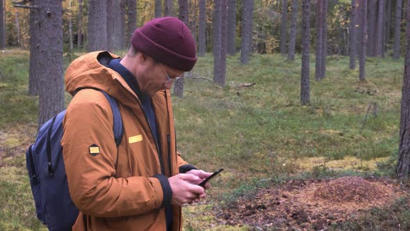 Portrait of a Caucasian Man with a Smartphone in His Hand