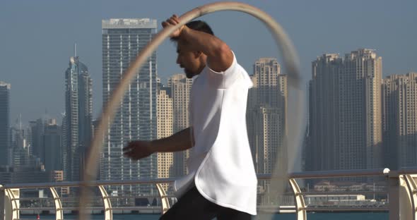 Sportsman is Spinning a Big Hoop Around Himself Wheel Gymnastics in Dubai alt