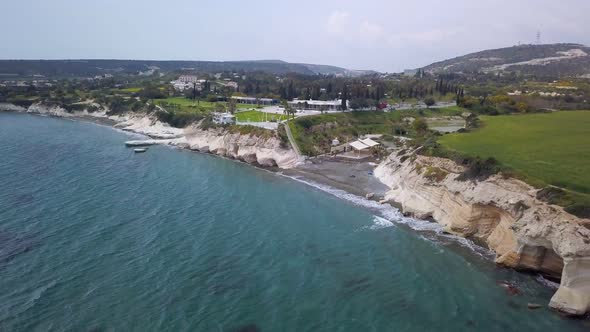 Aerial View of Blue Sea Water and Black Sand Shore of Resort Area in Cyprus in Cloudy Day