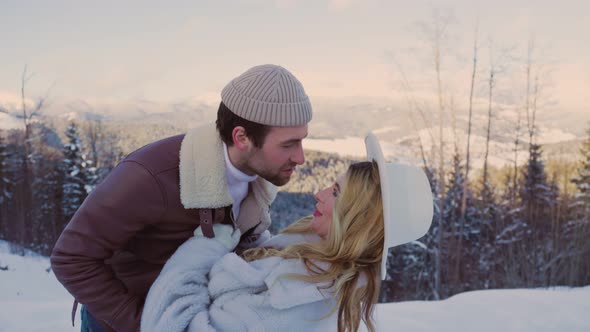 Couple Kissing on a Background of Mountains