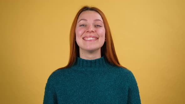 Young Red Hair Woman Posing Isolated on Yellow Color Background Studio alt