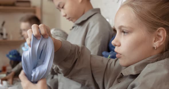 Modern Teaching of Children, a Girl Playing with a Slime, a Children's Laboratory for Teaching alt