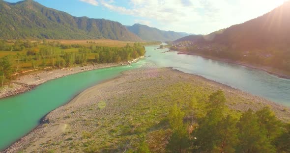 Low Altitude Flight Over Fresh Fast Mountain River with Rocks at Sunny Summer Morning. alt