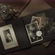 View over a photo album with family portraits and old camera - VideoHive Item for Sale