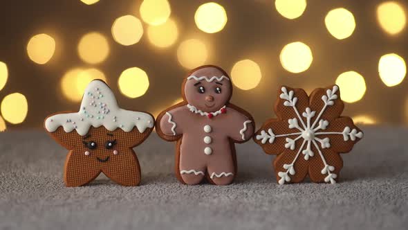 Christmas gingerbread cookies on the background of garlands of warm bokeh lights alt