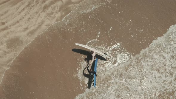 Aerial View of Surfers Greet Each Other