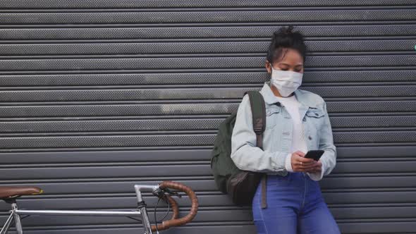 Woman wearing medical coronavirus mask on the street alt