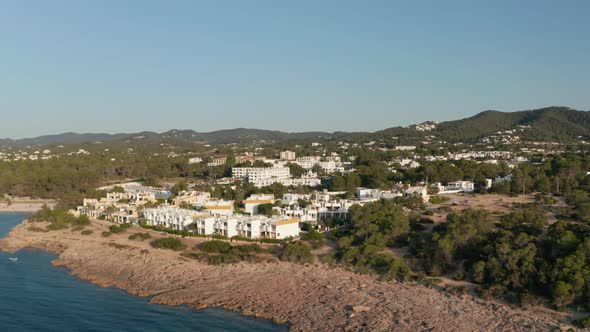 Aerial Forward View of a Silent and Calm Sea Surrounded with House and Resort Villa Along with alt