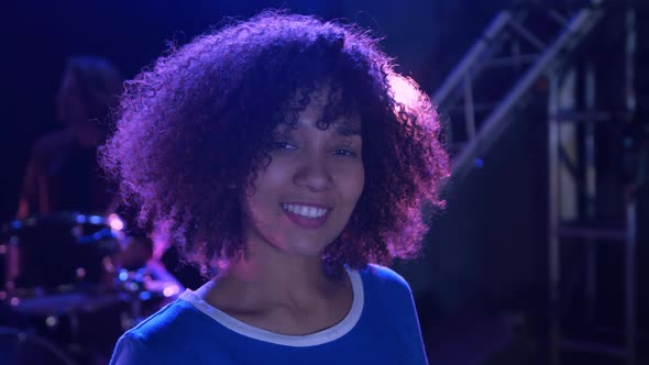 Female musician looking at camera and smiling alt