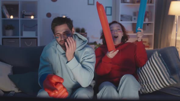 Sports Fans Cheering for Different Teams alt