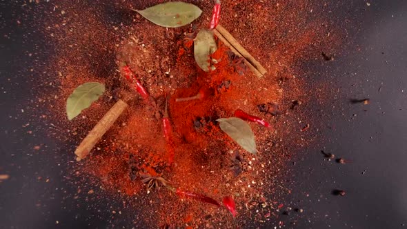 Exotic Spices and Chilli Pepper Flying Up and Falling Down in Slow Motion alt
