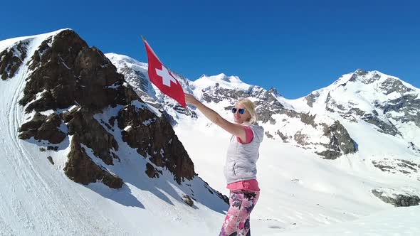 Girl on Diavolezza with Swiss Flag SLOW MOTION alt