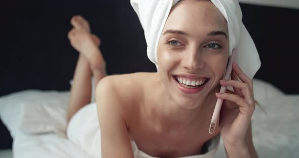 Smiling Woman Talking on Smartphone