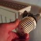 Hand adjusting temperature of radiator - VideoHive Item for Sale
