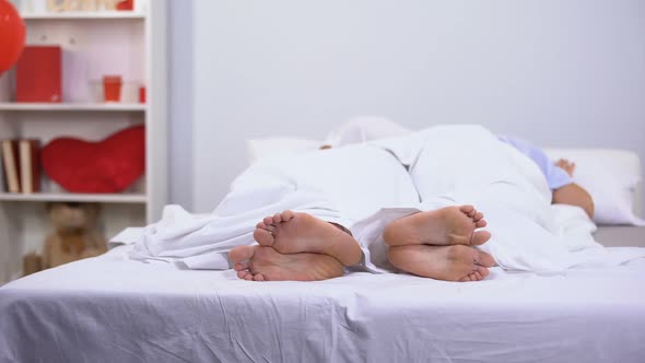 Husband and Wife Sleeping in Bed, Healthy Feet Seen Under Blanket, Antifungals alt