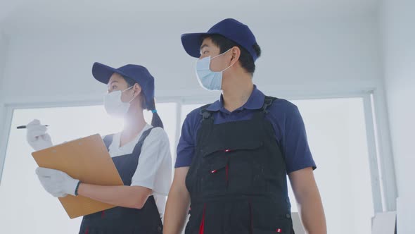 Asian construction worker people wear mask examine renovation in house discuss renovation plan. alt