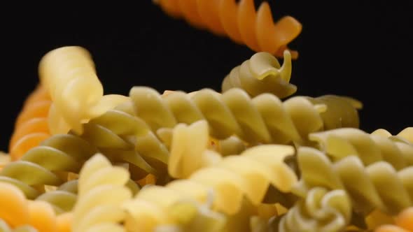 Macro shot of falling of colour spiral (pasta) on a heap