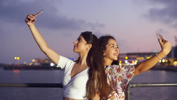 Fashionable Hipster Women Taking Selfies on Pier By the Sea