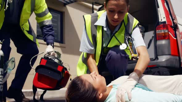 ambulance team treating a woman alt