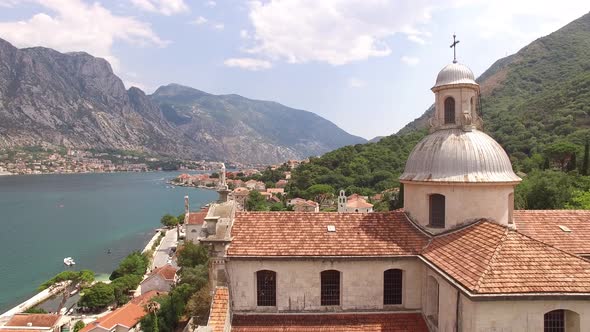 Drone View of the Tiled Roof and Barred Windows of the Church on the Banks of the Prcanj alt