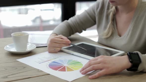 Business Woman Works with the Charts on the Tablet alt