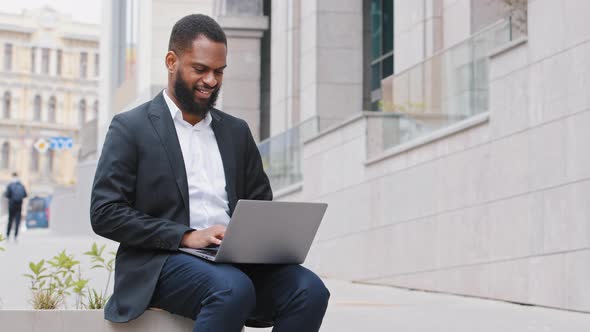 Male African American Millennial Student Typing on Laptop Keyboard Outdoors Mixed Race Ethnic alt