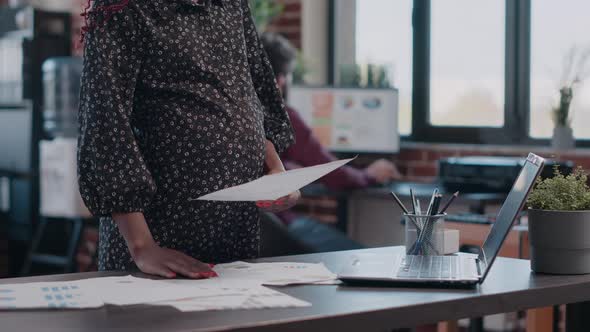 Close Up of Pregnant Business Woman Holding Hand on Belly alt