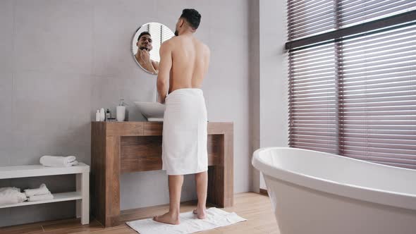 Full Length View Arabic Naked Muscular Athlete Indian Man with Towel on Hips Looking at Mirror in alt