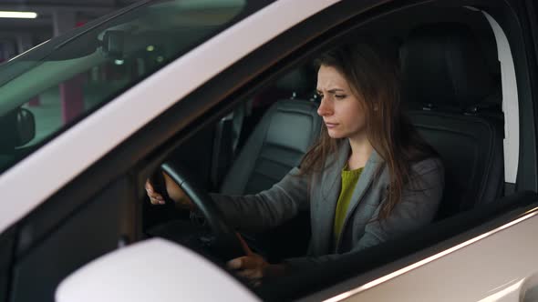 Woman Is Angry and Beating Her Head on the Steering Wheel Because Her Car Broke Down alt