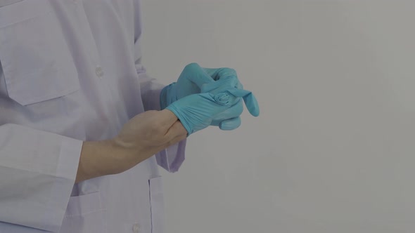 Wearing gloves. Male doctor wear blue rubber nitrile hands glove. Footage of Doc putting on gloves.