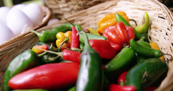 Capsicum vegetables and eggs in a wicker basket alt