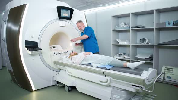 Magnetic Resonance Imaging in the Modern Hospital Adult Man Doctor Performs a Magnetic Tomographic alt