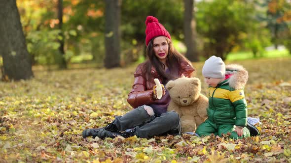 Young Mom or Nanny are Playing in the Park alt