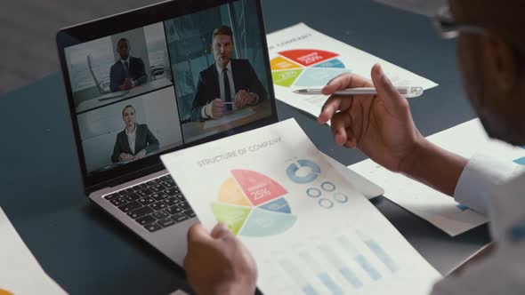 Young profesisonal man working with laptop indoors. Working male with laptop screen at the desk alt