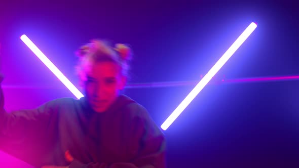 Blonde Artist Dancing Hiphop at Neon Lights Close Up alt