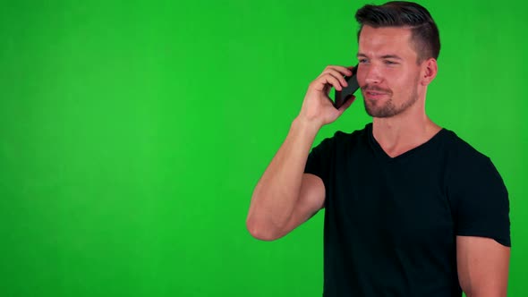 Young Handsome Caucasian Man Phones with Smartphone - Green Screen - Studio alt