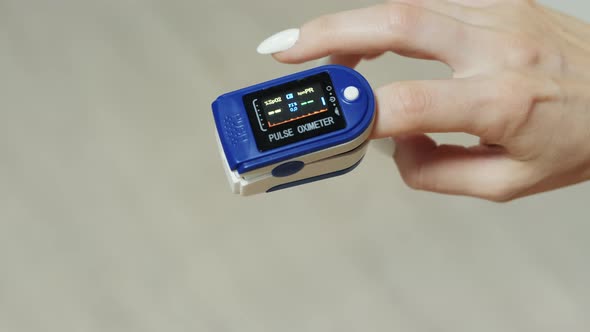 Closeup on a Finger in a Pulse Oximeter alt