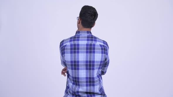 Rear View of Young Indian Hipster Man Waiting and Thinking