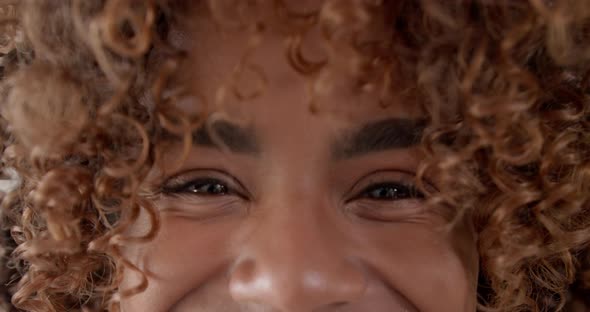 Close Up Shot of Young Female Opening Her Eyes and Looking to Camera and Smiling alt
