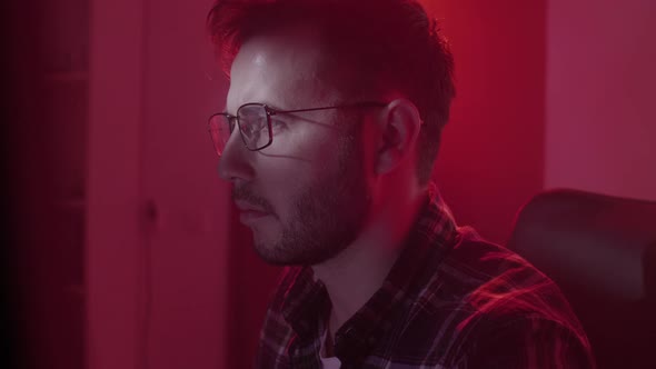 A Caucasian Man in Glasses Works on the Computer Inputs Code Types Very Fast on the Keyboard Checks alt