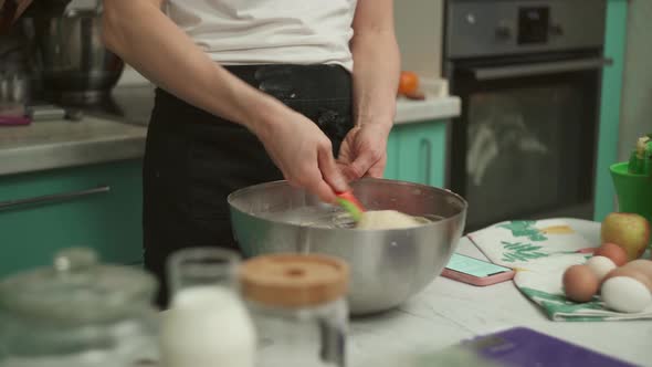 Crop Lady Mixing Batter Ingredients in Bowl in Kitchen