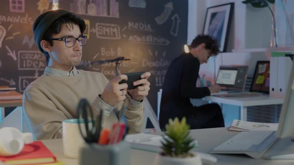 Joyful Employee Enjoying Video Game Playing at Work While Colleague ...