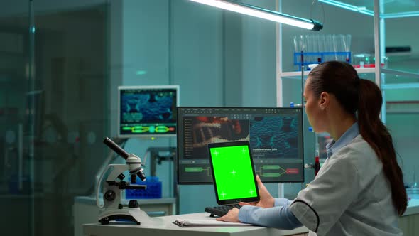Microbiologist Working on Notepad with Green Chroma Key Display alt