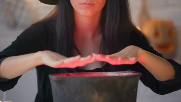 Young Witch In Black Dress Conjuring And Cooking Potion Halloween Eve