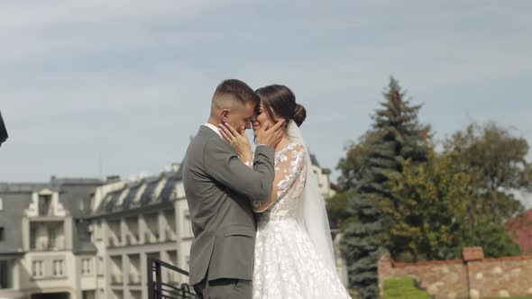 Lovely Newlyweds Caucasian Bride Embracing Groom in Park Making Kiss Wedding Couple Family Hugging alt