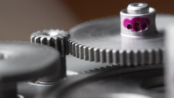 Gears rotating in a mechanical device. Machine metal gears rotating abstract alt