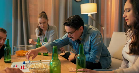 Man with Glasses Spends Evening in Living Room with Friends They Play Board Games Guy alt