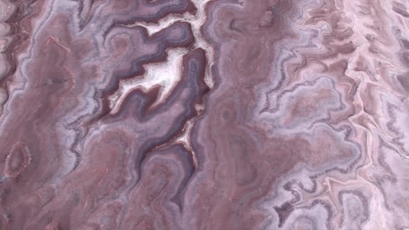 Aerial view of colorful desert textured terrain in Mars like landscape alt