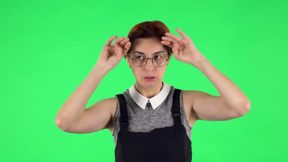 Portrait of Funny Girl in Glasses Is Cooling Herself By Her Hand, Suffering From High Temperature alt